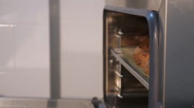 Pasta şefi tarçın rulo ile fırın levha dışarı çeker.
