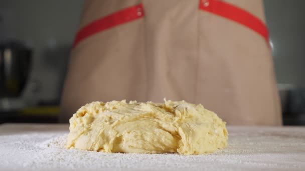 Pastelero espolvorea masa con harina en la mesa . — Vídeos de Stock