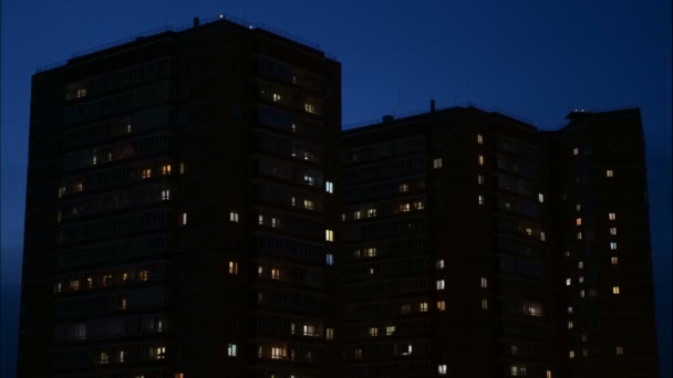 Närbild till fönster i flerbostadshus på natten, — Stockvideo
