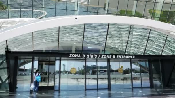 Baku, Azerbaigian, 20-05-2019: Vista all'ingresso dell'aeroporto di Heydar Aliyev con donna che entra dalla porta . — Video Stock