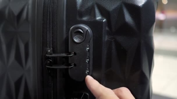 Mans hands open suitcase combination lock on the suitcase. — Stock Video