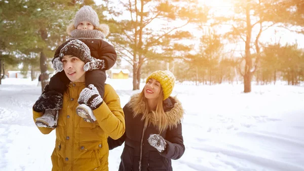 Feliz jovem família estão andando no parque da cidade de inverno juntos . — Fotografia de Stock