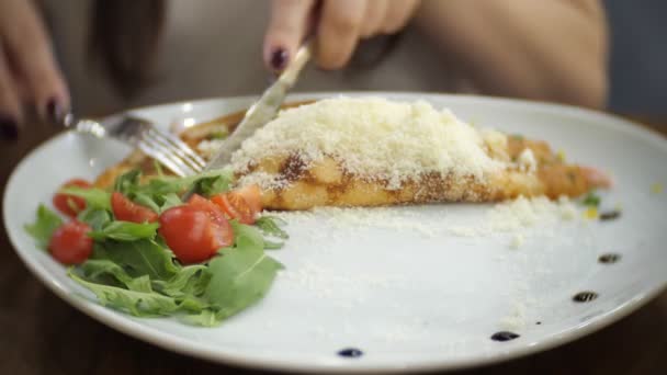 Bonita mujer está cenando panqueques con jamón, queso, verduras y tomates . — Vídeos de Stock