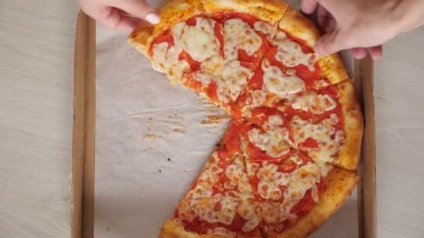 Casal leva deliciosas fatias de pizza coloridas da caixa de artesanato — Vídeo de Stock