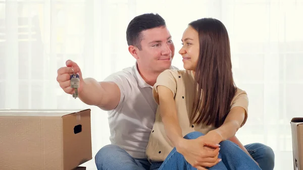 husband gives keys to nice new house to smiling wife