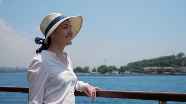 Жінка насолоджується подорожжю і дивиться на відстань, стоячи на палубі — стокове відео
