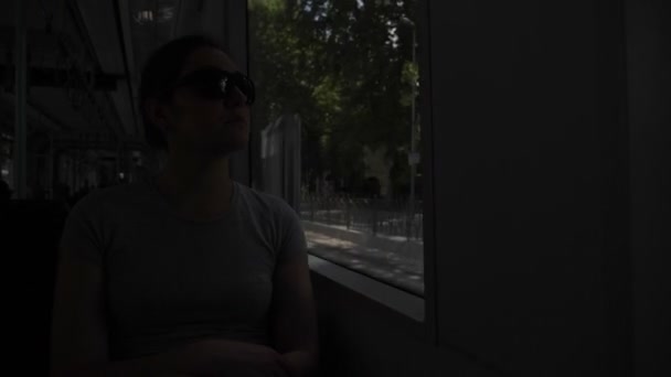 Tourist sits at window and travels by tram to city center — Stock Video