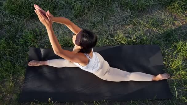 Samice jóga dělá strečink na gymnastické podložce — Stock video