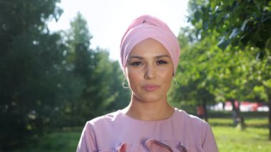 Mor tesettüre sahip profesyonel model düz duruyor