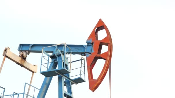 Oil pump jack rocking with pipeline. Extraction of oil — Stock Video