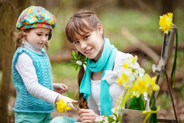 Portrait of two sisters  in the spring forest. Smiling cute sist