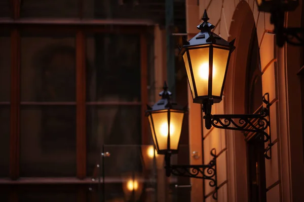Old fashioned street lamp at night. Brightly lit street lamps at