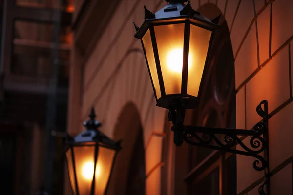 Old fashioned street lamp at night. Brightly lit street lamps at