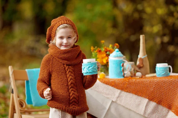 Adorable little girl on picnic in autumn park. Cute little girl