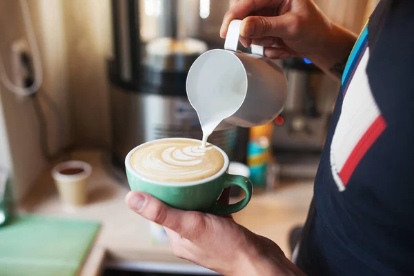 Cerrar manos baristas verter leche tibia en taza de café para makin —  Fotos de Stock