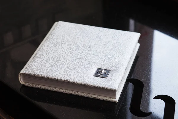 Photo book with a cover of genuine leather. White color with dec
