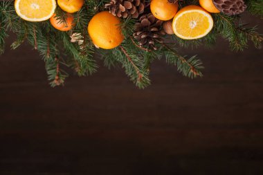 Koyu ahşap sırtında Noel süsüyle fidan dalları