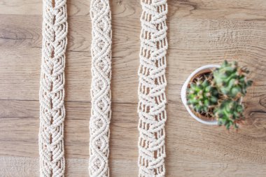Handmade macrame pattern close up . Natural cotton threads. Stylish belt for women 's dress.  Macrame braiding and cotton threads. Female hobby. ECO friendly modern knitting DIY natural decoration concept. clipart