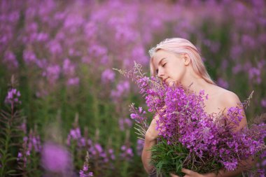 Beauty romantic girl outdoors. Beautiful teenage model with pink hair girl on the field of fireweed in sunrise.  clipart