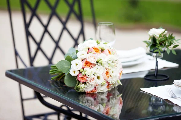 Wonderful bride  bouquet of flowers laying on black glass table. Beautiful wedding and holiday bouquet