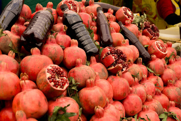 Ripe red pomegranates on the market counter