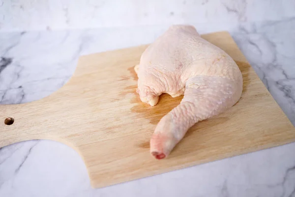 Raw chicken thighs meat on a wooden cutting board. Cooking chicken meat. Raw chicken meat. Healthy food concept