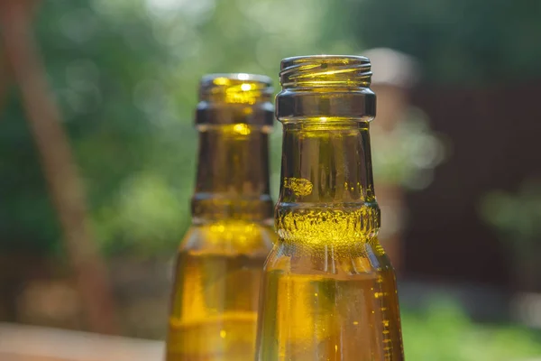 The necks of the bottles of beer