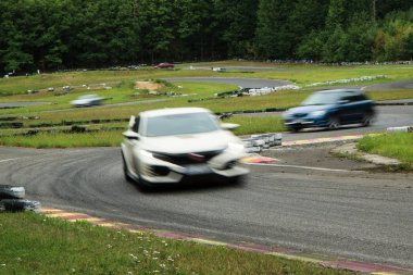 A picture from a small race track, where the free rides are performed. Drivers can drive for fun during the weekend free races.  clipart