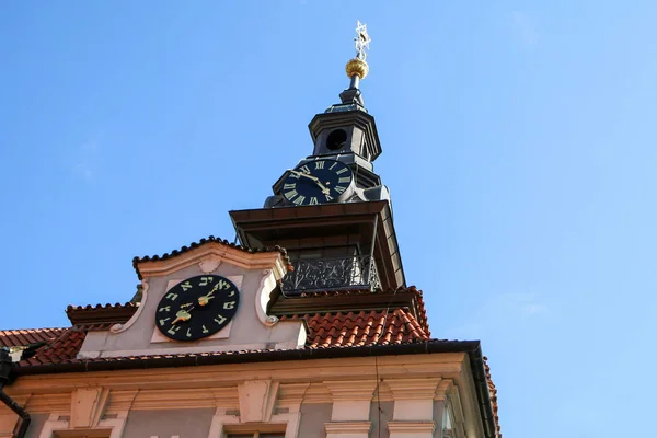 The comparisson of two clocks. The regular with arabic numbers and the jewis one. They are on one tower of the church.