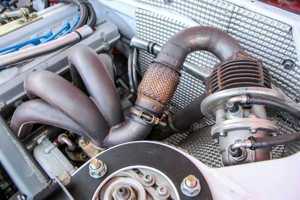 A detail of the sports car engine. It is a historic rallye car from the past.