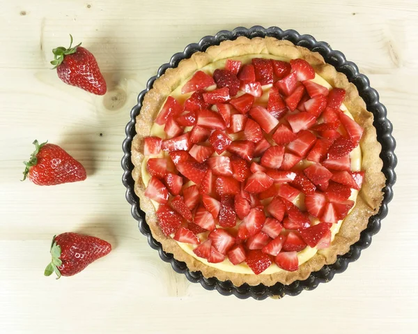 Strawberry pie on wooden background - top view