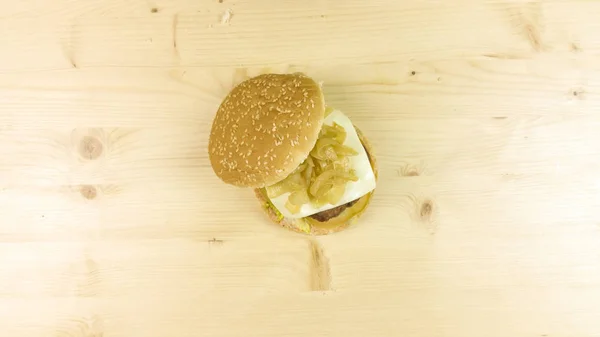 Making burger and chips on wooden background - top view