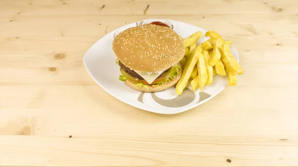 Burger and chips on wooden background