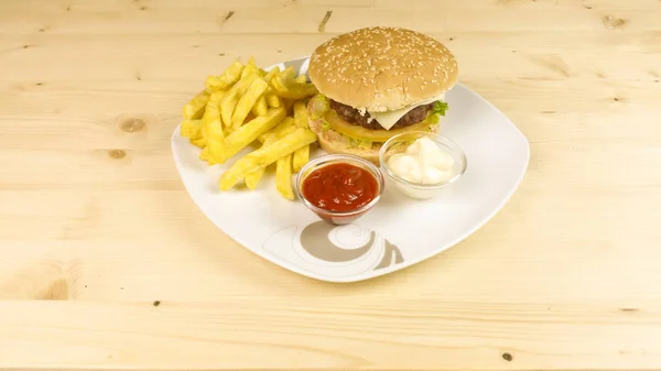 Burger and chips on wooden background