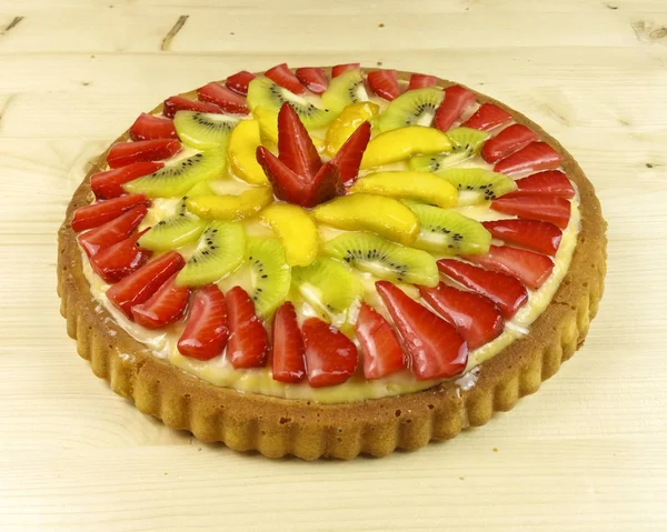 Fruit tart on wooden background - top view