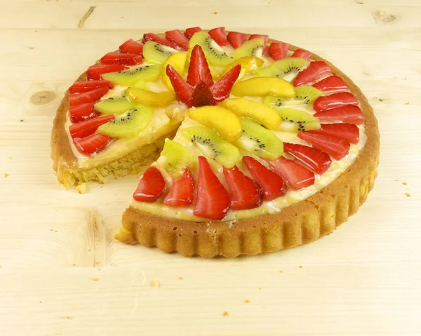 Fruit tart on wooden background - top view