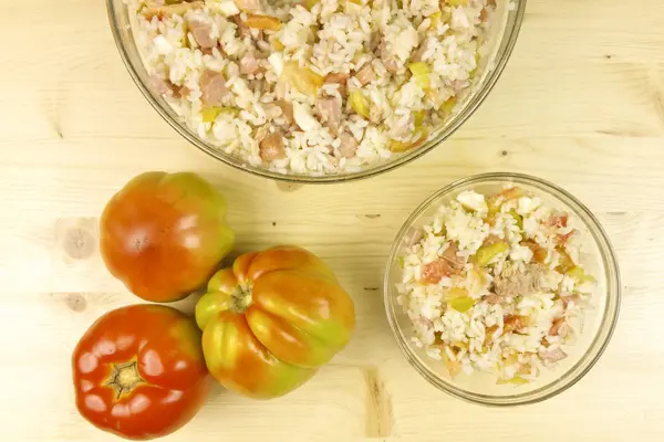 Domates ve ahşap zemin - üstten görünüm üzerine saydam bir kasede basit pirinç salatası