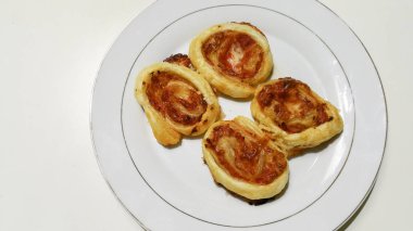 puff pastry pizza on white plate