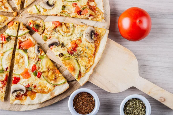 Zucchini vegan pizza with tomato, oregano and merken