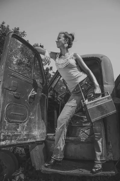 Black and white photo of girl with vintage radio near retro truck