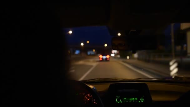 Young girl driving a car on city road night. — Stock Video