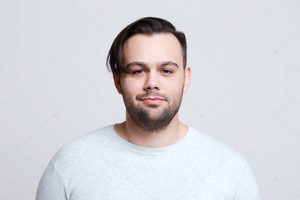 Portrait of young man dressed in sweater over white background