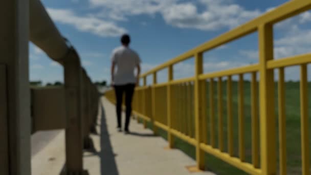 Blurred Perspective Background Young Man Walking Bridge Sunny Day — Stock Video