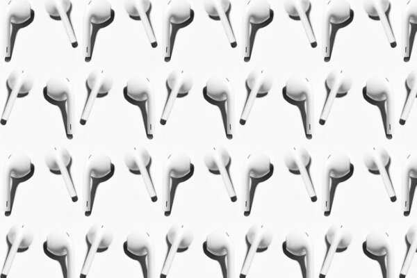 Pattern of wireless earphones isolated on white background.