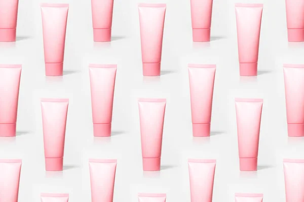 Patroon Van Pastel Roze Crème Buizen Geïsoleerd Witte Achtergrond — Stockfoto