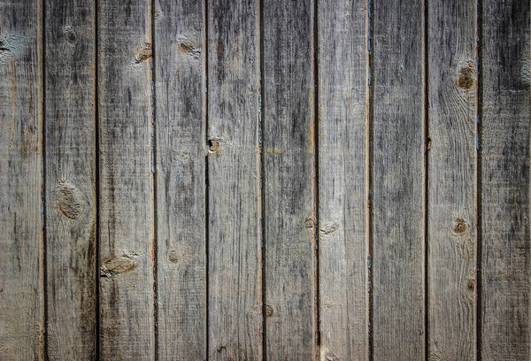 Vertical boards of a wooden wall / table with old remnants of paint on them