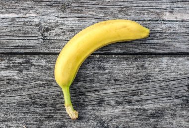 yellow banana on the old wooden surface