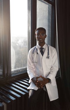 Yakışıklı doktor ile stetoskop beyaz arka plan üzerinde beyaz önlük içinde