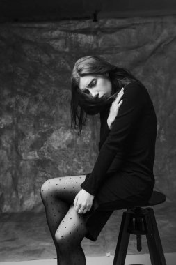 Tuvalin arka planında elbise giymiş güzel bir kadın. Resim.