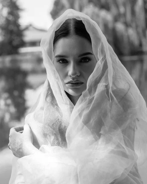 Beautiful girl with clean and pigmented skin on the nature on the lake